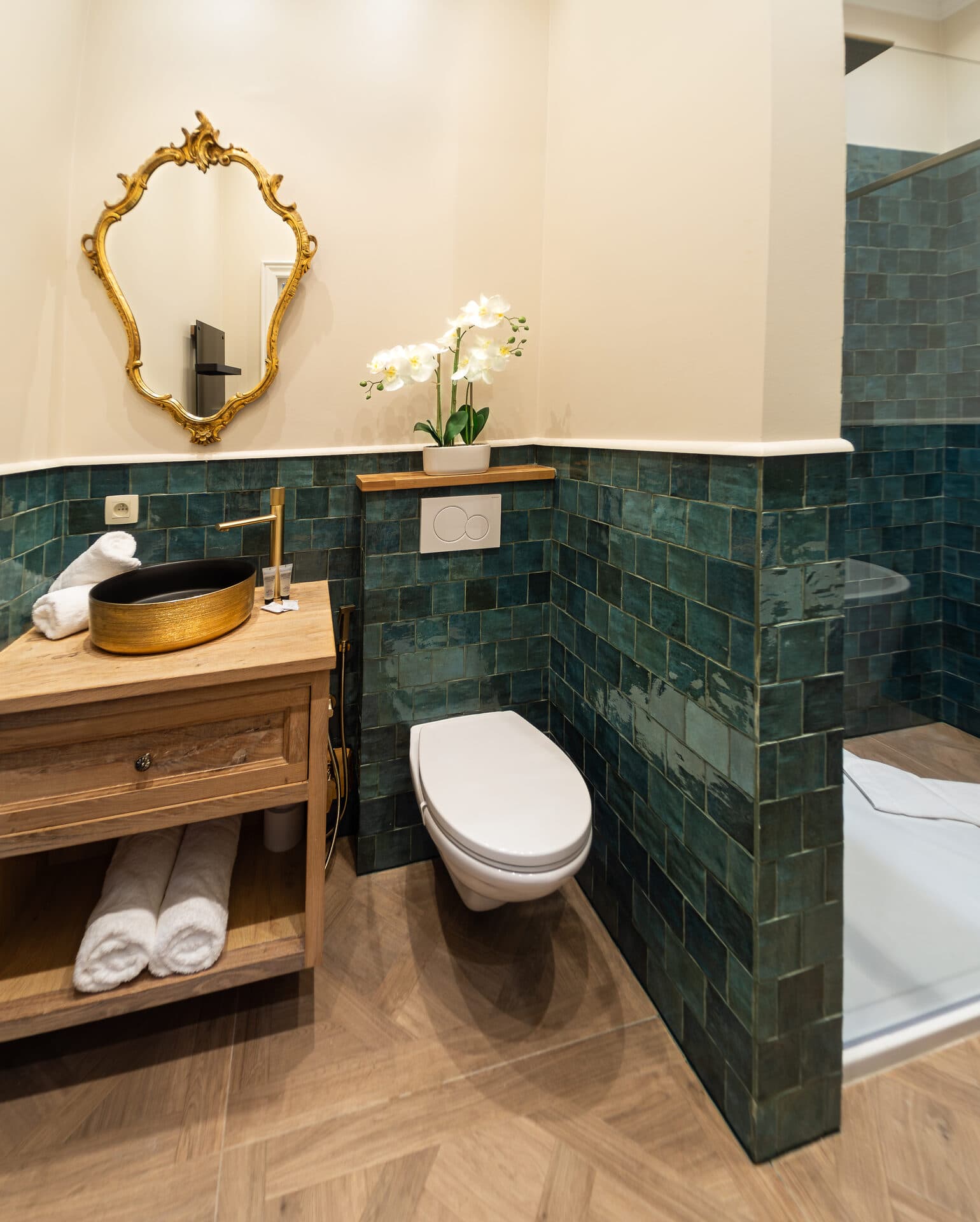 Green zellige tile bathroom with gold fixtures in the Deluxe Double Room